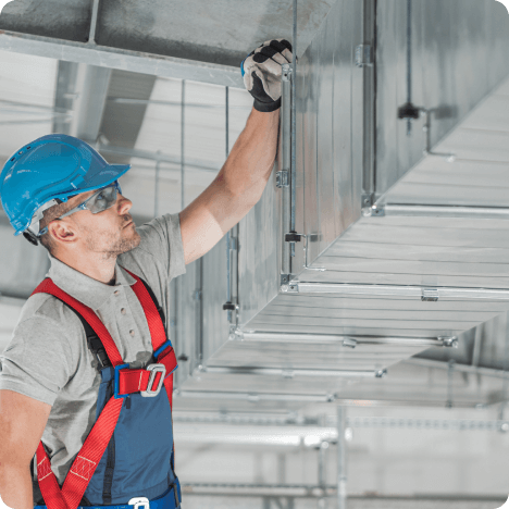 A worker looking at HVAC system