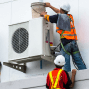 Two workers working on outside fan